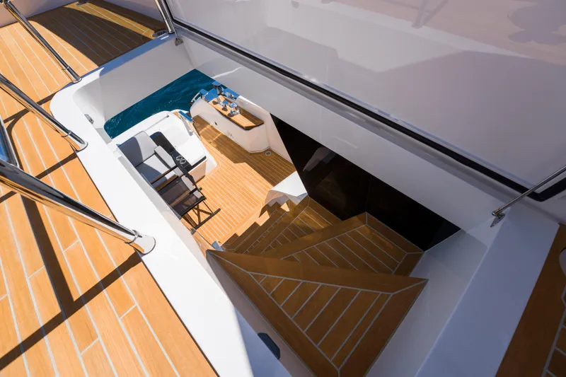 Slide: The Image of Luxurious Pearl 72 yacht interior with wooden stairs and seating area, 2024 model. - 110