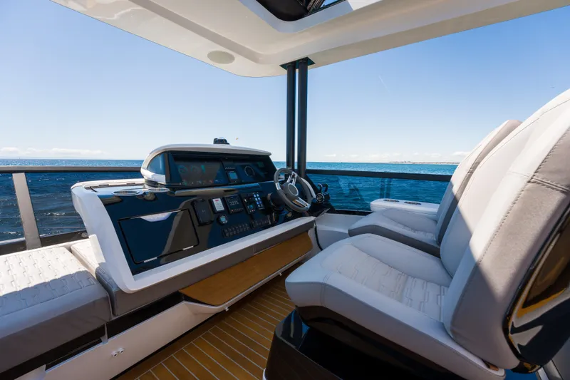 Slide: The Image of Luxurious helm of 2024 Pearl 72 yacht with modern controls and ocean view. - 119