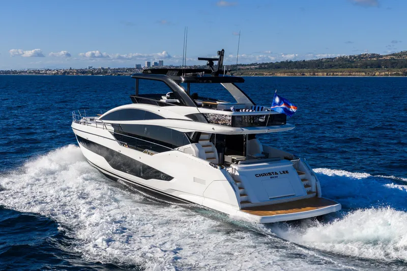 Slide: The Image of Luxurious 2024 Pearl 72 yacht cruising on open sea with scenic coastline backdrop. - 12