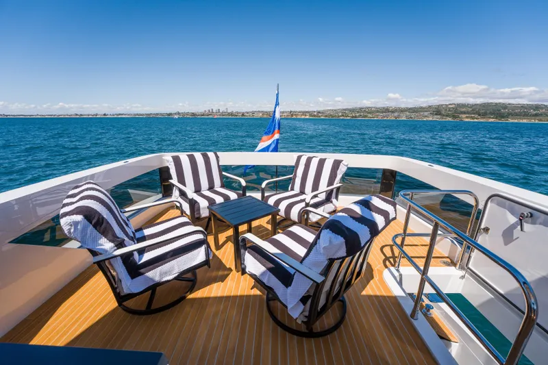 Slide: The Image of Luxurious Pearl 72 yacht deck with striped chairs, ocean view, 2024 model. - 122