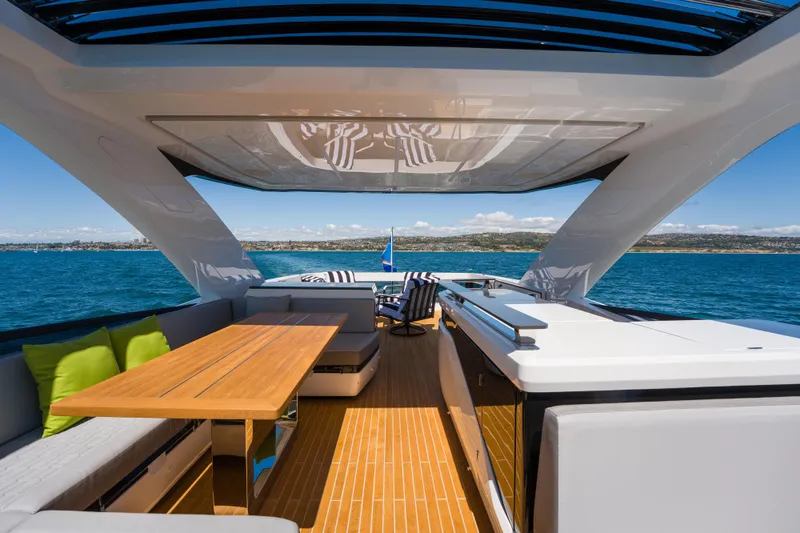 Slide: The Image of Luxurious 2024 Pearl 72 yacht deck with seating, table, and ocean view. - 124