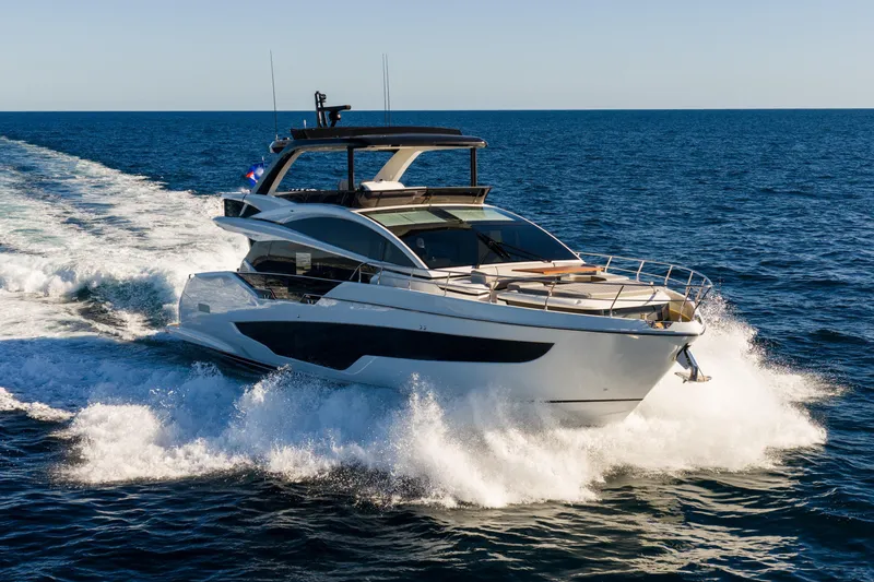 Slide: The Image of Luxurious 2024 Pearl 72 yacht cruising on open sea under clear blue sky. - 14