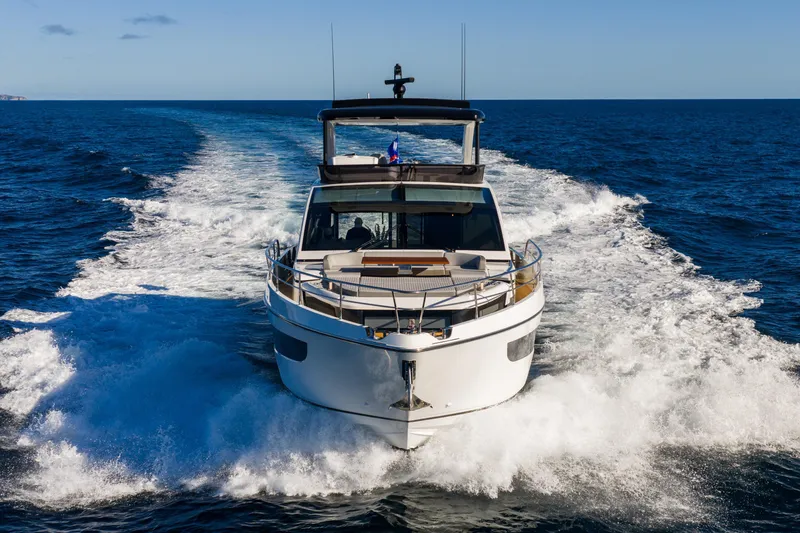 Slide: The Image of 2024 Pearl 72 yacht cruising on open sea, leaving a trail of white waves. - 15