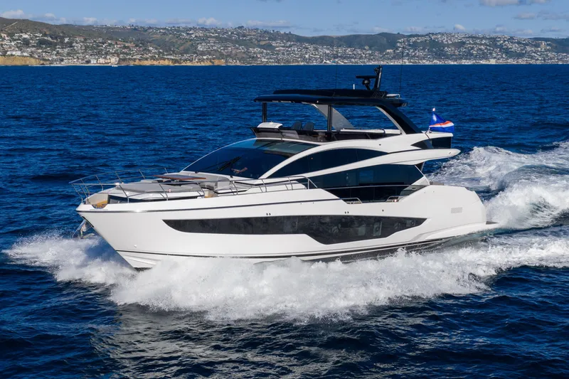 Slide: The Image of Luxurious 2024 Pearl 72 yacht cruising on open sea with scenic coastline backdrop. - 16