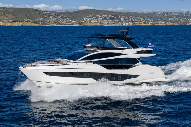 Slide: The Image of Luxurious 2024 Pearl 72 yacht cruising on blue ocean near scenic coastline. - 17