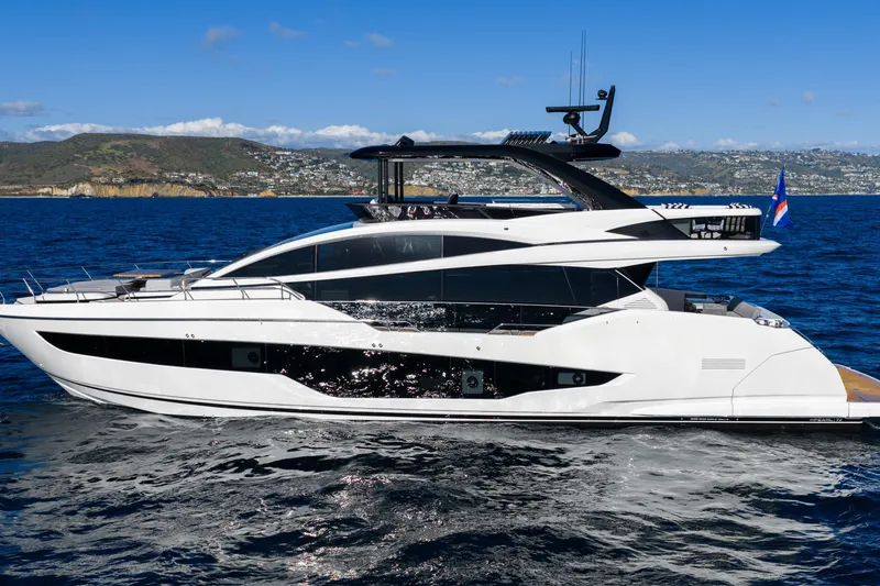 Slide: The Image of 2024 Pearl 72 yacht cruising on blue ocean with scenic coastal backdrop. - 24