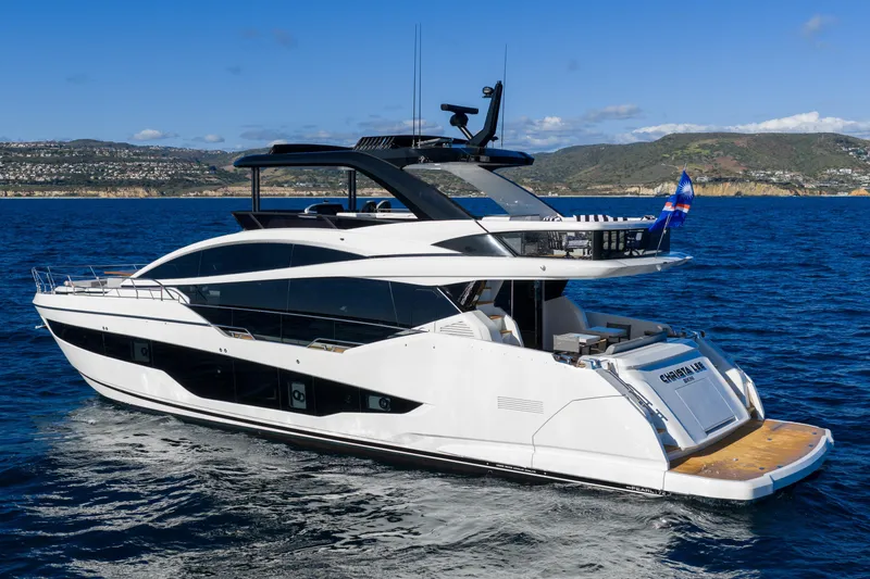 Slide: The Image of Luxurious 2024 Pearl 72 yacht cruising on blue ocean with scenic coastline backdrop. - 25