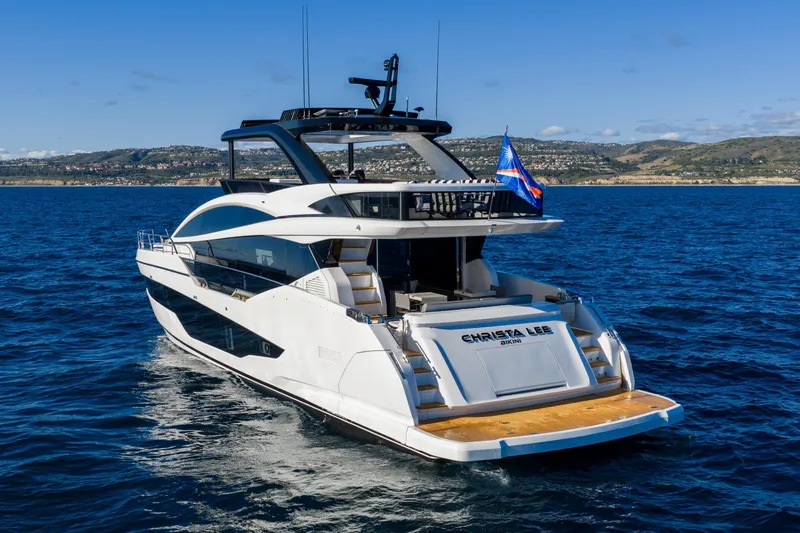 Slide: The Image of Luxurious 2024 Pearl 72 yacht cruising on open sea with scenic coastline backdrop. - 26