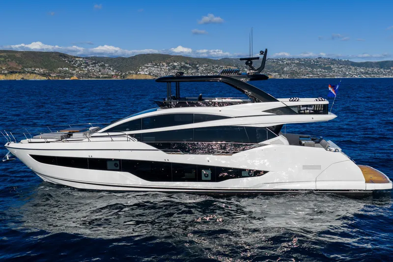 Slide: The Image of Luxurious 2024 Pearl 72 yacht cruising on blue ocean with scenic coastal backdrop. - 32