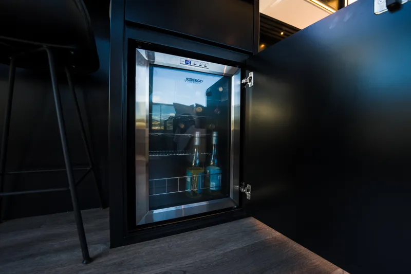 Slide: The Image of Modern Pearl 72 mini fridge, 2024 model, with beverages inside, in a sleek kitchen setting. - 48
