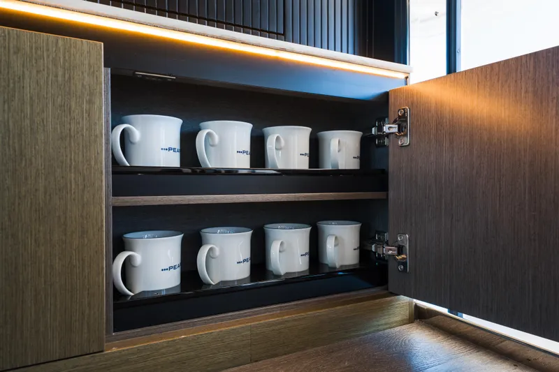 Slide: The Image of Open cabinet with Pearl-branded mugs, modern design, 2024 Pearl 72 model. - 50