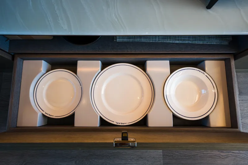 Slide: The Image of Drawer with Pearl 72 plates, neatly organized in a modern kitchen setting. - 51