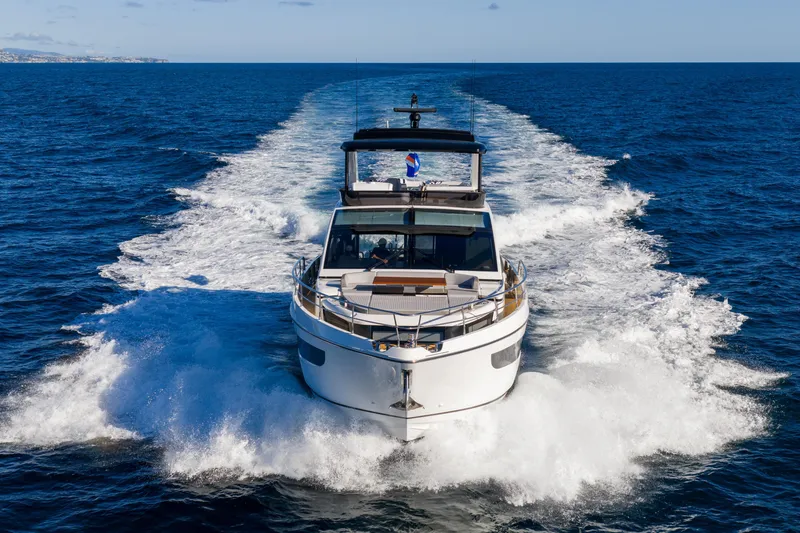 Slide: The Image of 2024 Pearl 72 yacht cruising on open sea, leaving a foamy wake behind. - 6