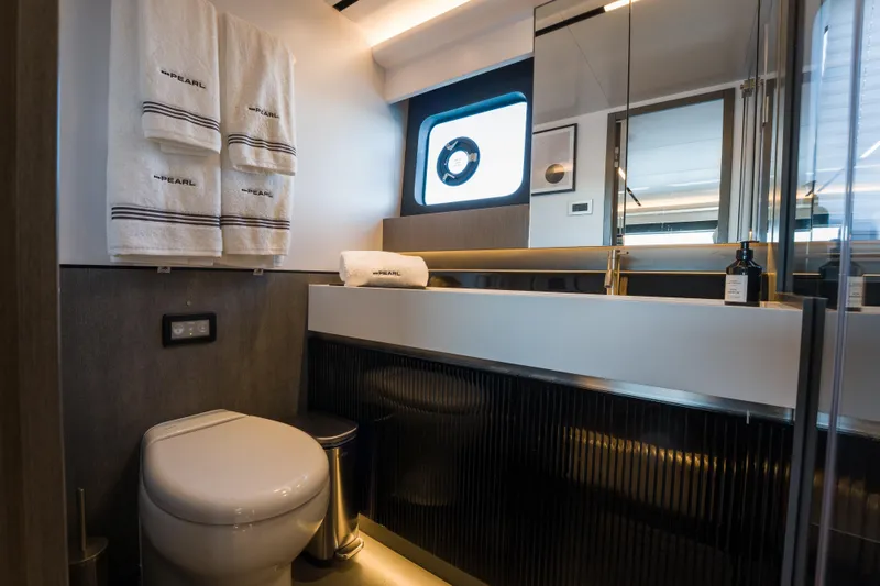 Slide: The Image of Luxurious bathroom in 2024 Pearl 72 yacht with modern fixtures and branded towels. - 69
