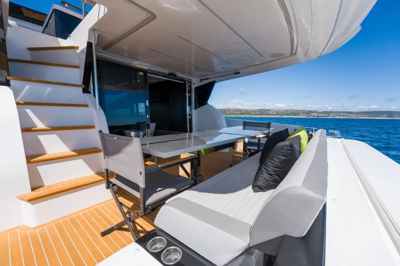 Slide: The Image of Luxurious 2024 Pearl 72 yacht deck with seating, table, and ocean view. - 85