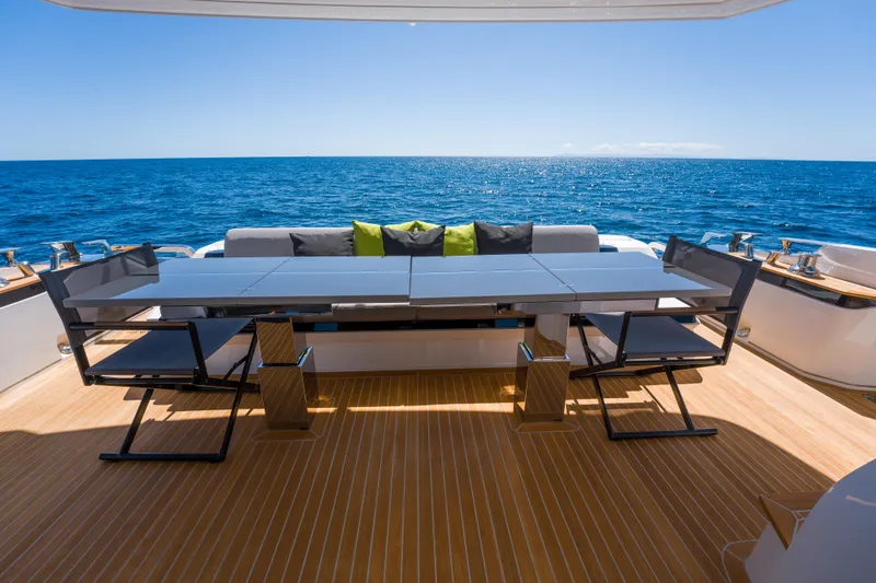 Slide: The Image of Luxury yacht Pearl 72, 2024 model, with elegant deck dining area overlooking the ocean. - 88