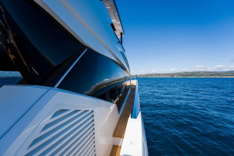 Slide: The Image of 2024 Pearl 72 yacht cruising on open sea under clear blue sky. - 93