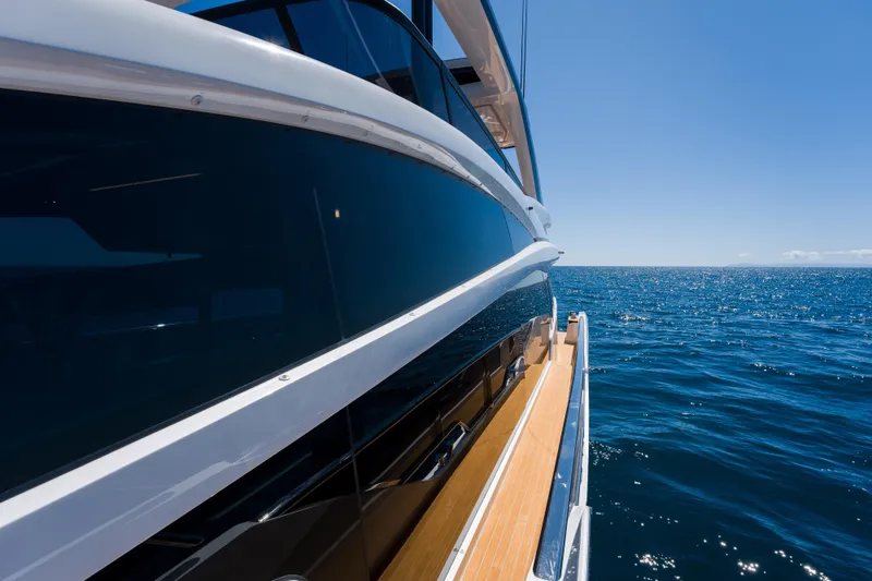 Slide: The Image of Luxurious 2024 Pearl 72 yacht cruising on open sea under clear blue sky. - 94