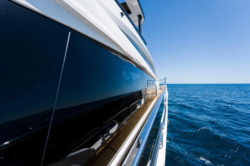 Slide: The Image of 2024 Pearl 72 yacht cruising on open sea under clear blue sky. - 96