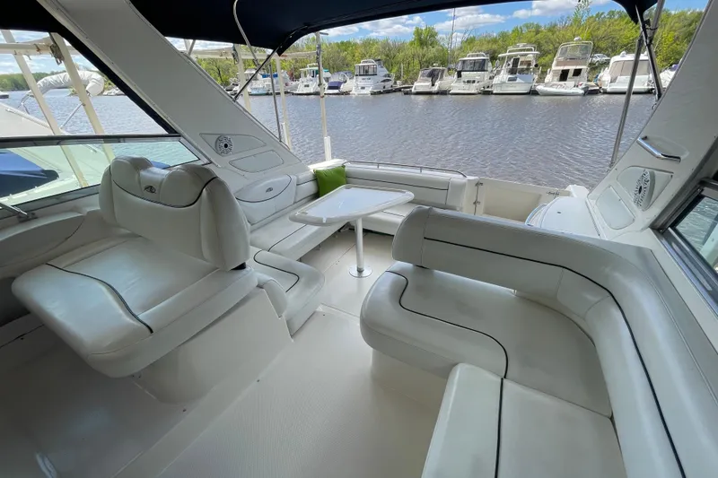 Slide: The Image of Luxurious 1997 Bayliner 4085 Avanti yacht interior with white seating and waterfront view. - 10