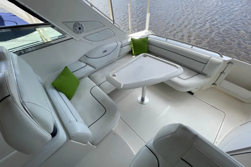 Slide: The Image of 1997 Bayliner 4085 Avanti boat interior with white seating and green cushions. - 11