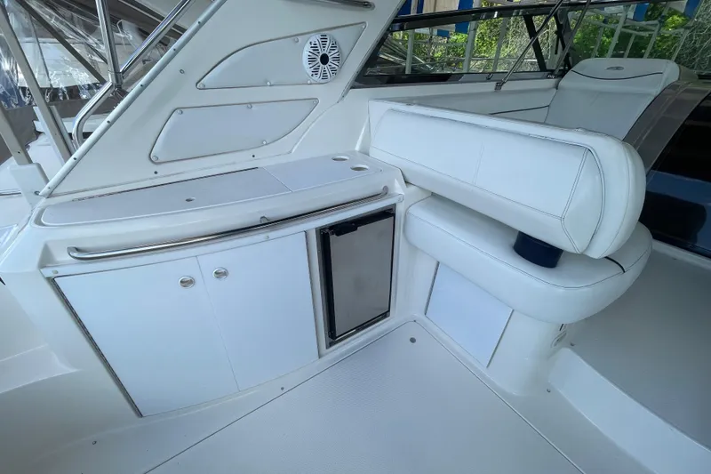 Slide: The Image of 1997 Bayliner 4085 Avanti interior with white seating and compact kitchenette. - 12