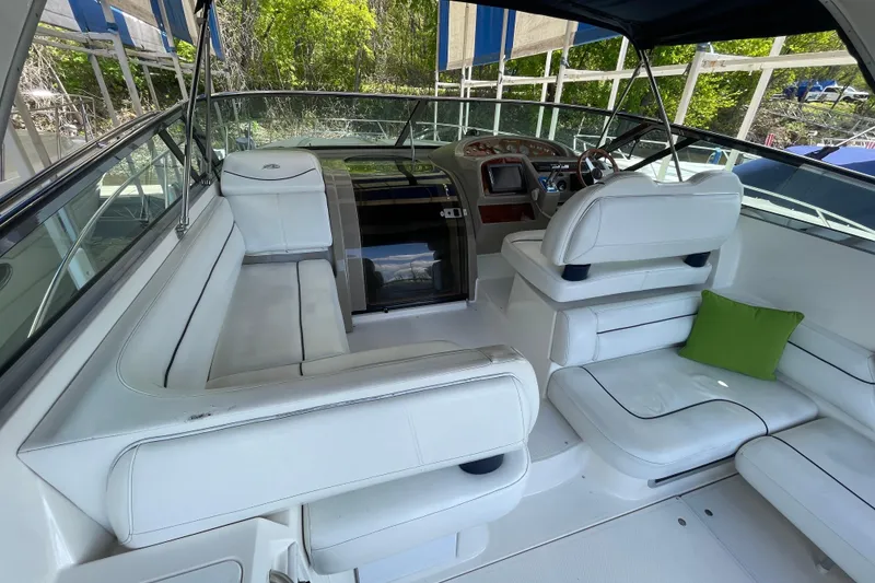 Slide: The Image of 1997 Bayliner 4085 Avanti boat interior with white seating and green cushion. - 13