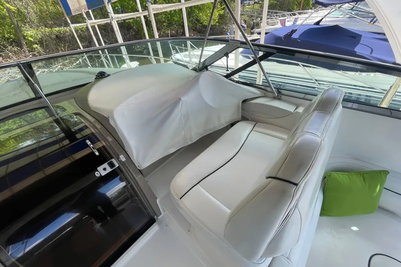 Slide: The Image of 1997 Bayliner 4085 Avanti cockpit with white seating and green cushion. - 14