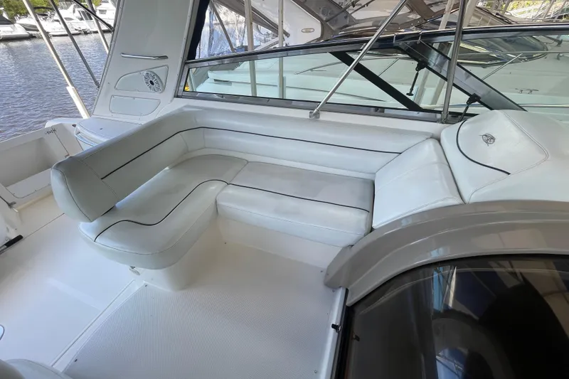 Slide: The Image of 1997 Bayliner 4085 Avanti boat interior with white cushioned seating and sleek design. - 16