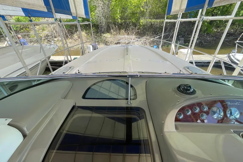 Slide: The Image of 1997 Bayliner 4085 Avanti yacht dashboard with gauges, docked under canopy. - 20