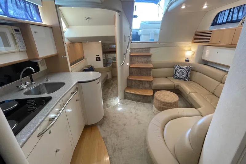 Slide: The Image of Luxurious interior of a 1997 Bayliner 4085 Avanti yacht with modern kitchen and seating area. - 22