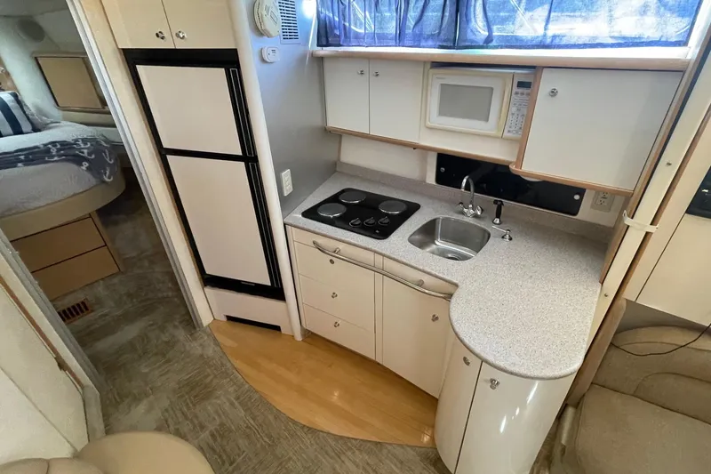 Slide: The Image of 1997 Bayliner 4085 Avanti yacht interior kitchen with stove, sink, and microwave. - 24