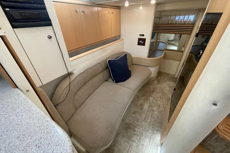 Slide: The Image of Interior of 1997 Bayliner 4085 Avanti yacht with beige seating and wooden cabinetry. - 25
