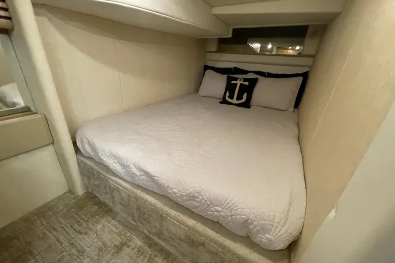 Slide: The Image of Cozy cabin bedroom in 1997 Bayliner 4085 Avanti with nautical-themed decor. - 26