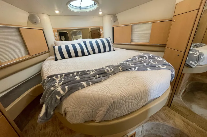 Slide: The Image of Luxurious cabin interior of a 1997 Bayliner 4085 Avanti with cozy bedding and nautical decor. - 27