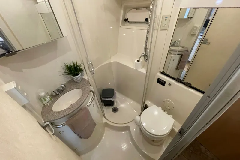 Slide: The Image of Compact bathroom in 1997 Bayliner 4085 Avanti yacht with shower, sink, and toilet. - 28
