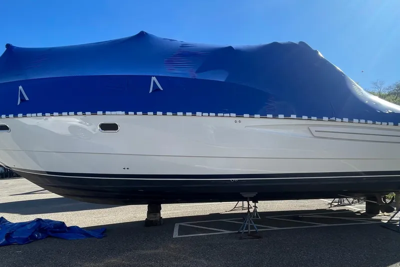 Slide: The Image of 1997 Bayliner 4085 Avanti boat covered with blue tarp, parked on stands. - 38