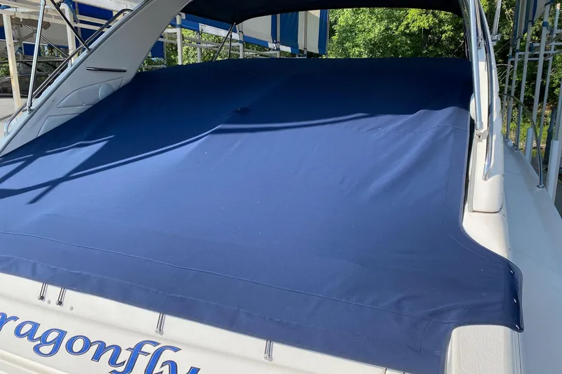 Slide: The Image of 1997 Bayliner 4085 Avanti boat with blue cover, docked outdoors. - 46
