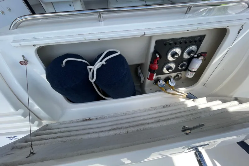 Slide: The Image of 1997 Bayliner 4085 Avanti boat control panel with fire extinguishers and fenders. - 7