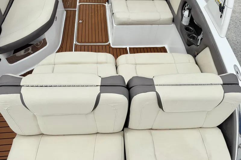 Slide: The Image of Luxurious seating on a 2018 Bryant Calandra boat with elegant white upholstery and wood flooring. - 11