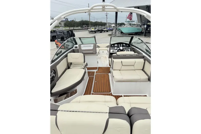 Slide: The Image of Interior view of a 2018 Bryant Calandra boat with luxurious seating and modern dashboard. - 12