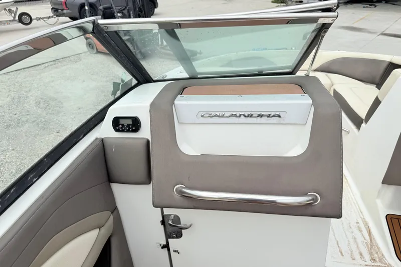 Slide: The Image of 2018 Bryant Calandra boat interior with windshield and seating area. - 15