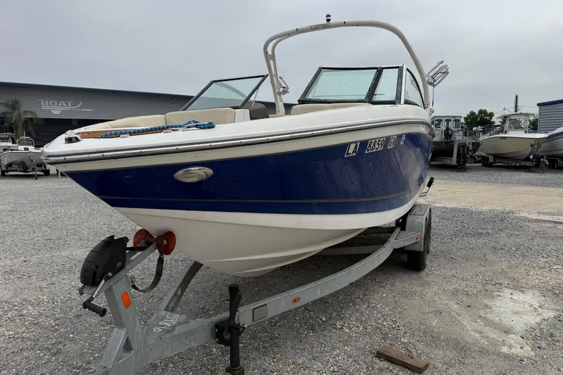 Slide: The Image of 2018 Bryant Calandra boat on trailer in a gravel lot, overcast sky. - 6