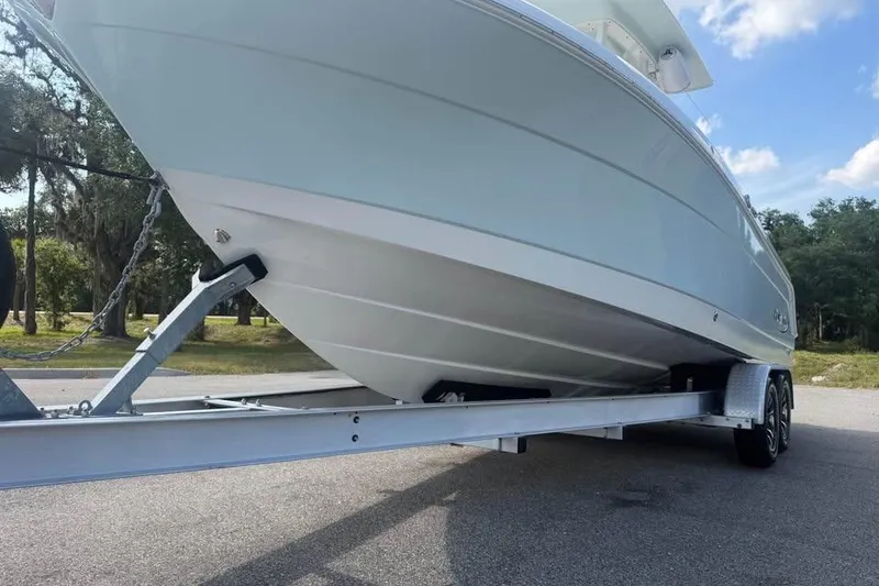 Slide: The Image of 2018 Robalo R242 Center Console boat on trailer, parked outdoors. - 10