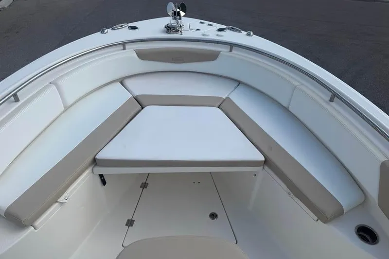Slide: The Image of 2018 Robalo R242 Center Console boat with cushioned seating area. - 14