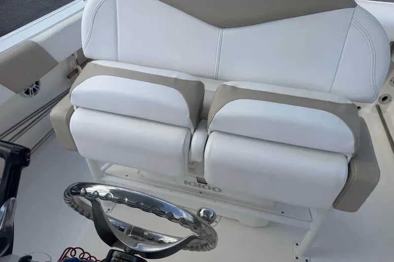 Slide: The Image of 2018 Robalo R242 Center Console boat interior with white and beige seating. - 15