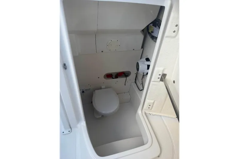 Slide: The Image of Interior view of 2018 Robalo R242 Center Console boat's compact bathroom. - 18