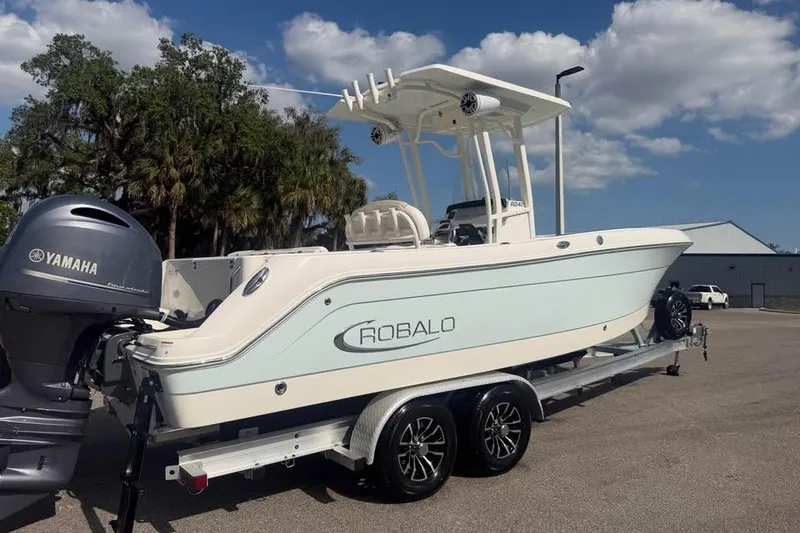 Slide: The Image of 2018 Robalo R242 Center Console boat on trailer with Yamaha engine, parked outdoors. - 5