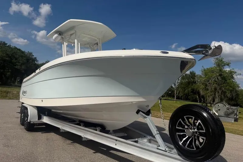 Slide: The Image of 2018 Robalo R242 Center Console boat on trailer under clear blue sky. - 8