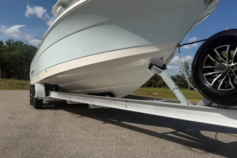 Slide: The Image of 2018 Robalo R242 Center Console boat on trailer, sunny day. - 9